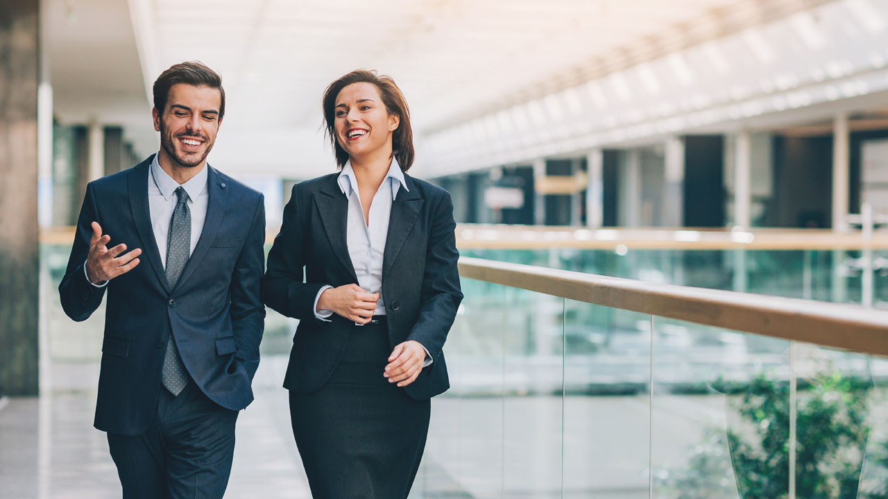 A man and woman in suit walking